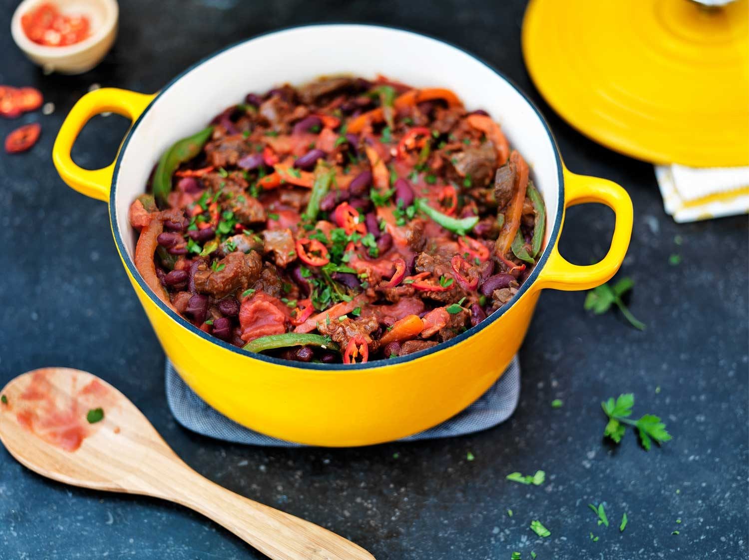 Large enameled Dutch oven filled with beef stew and vegetables