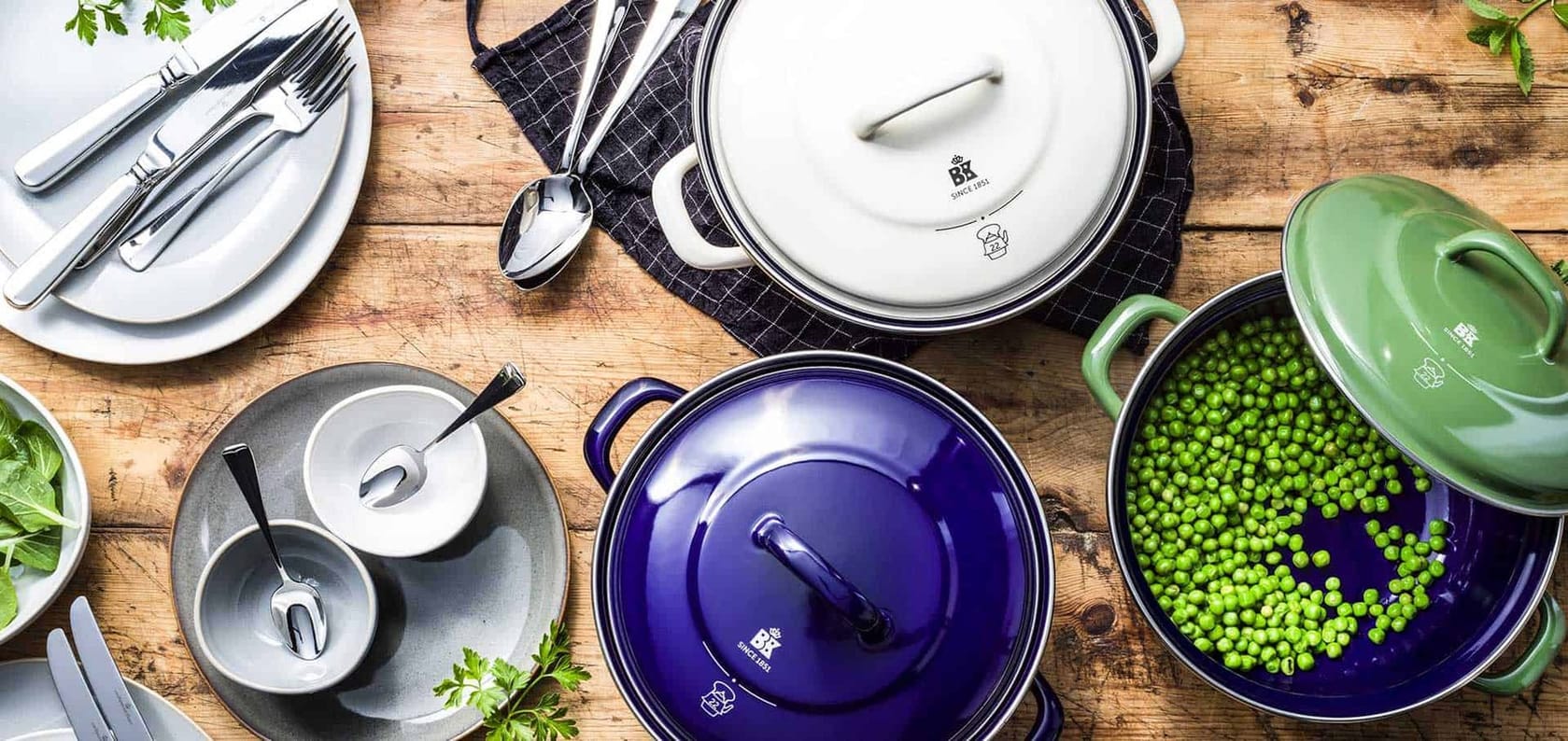 Enameled Dutch oven on a set dinner table with side dishes