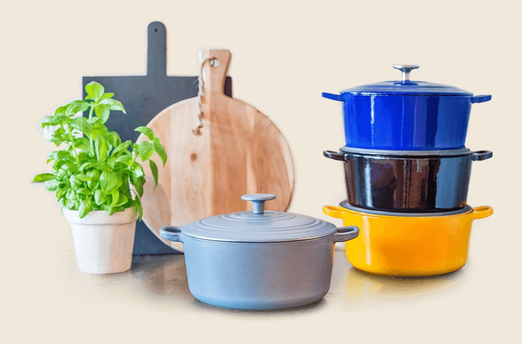 Two enameled Dutch ovens stacked on a turntable in blue and mustard glaze